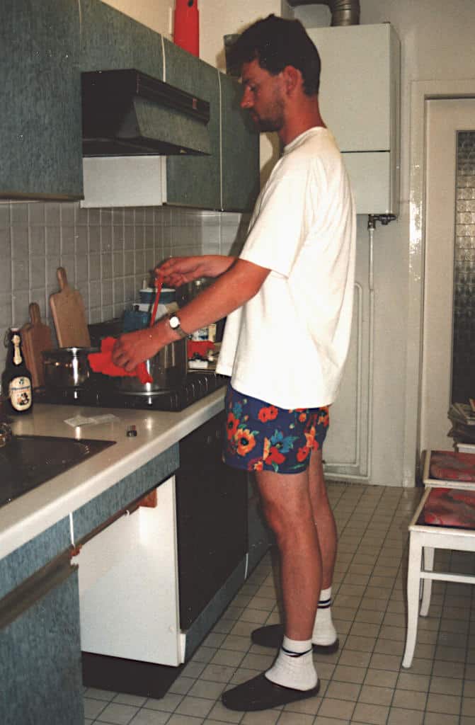 En ung mann står på kjøkkenet og brygger øl